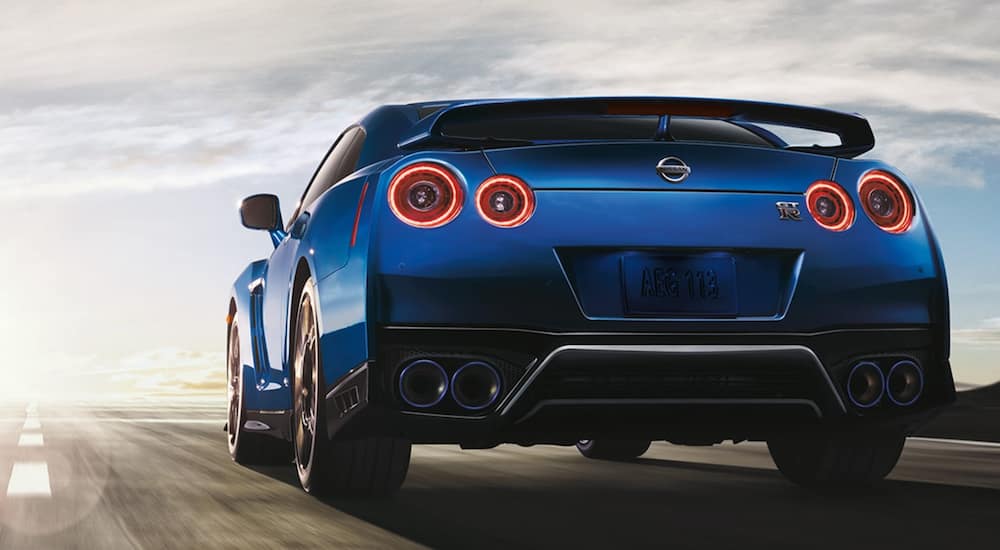 A blue 2021 Nissan GT-R is shown from the back driving on a track.