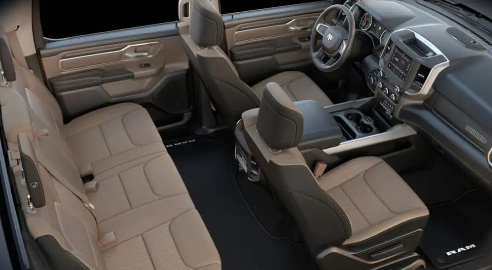 The interior of a 2021 Ram 1500 Big Horn/Lone Star shows two rows of seating, steering wheel, and infotainment screen.