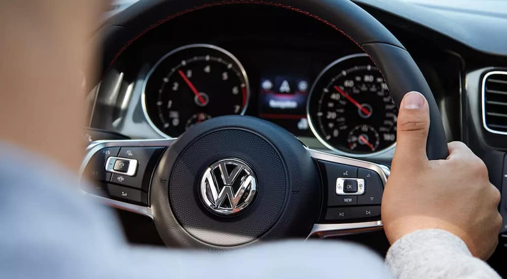 A close up shows the steering wheel of a 2021 Volkswagen Golf GTI.