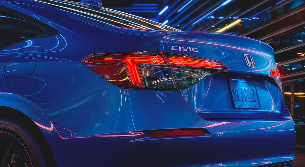 A close up shows the trunk and taillights on a blue 2022 Honda Civic Sport.
