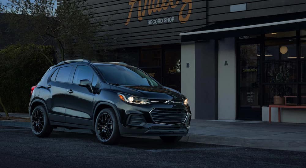 A black 2021 Chevy Trax is parked outside of a record store.