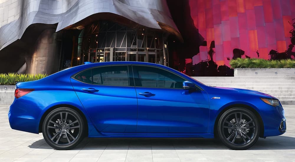 A blue 2020 Acura TLX is shown parked from the side.