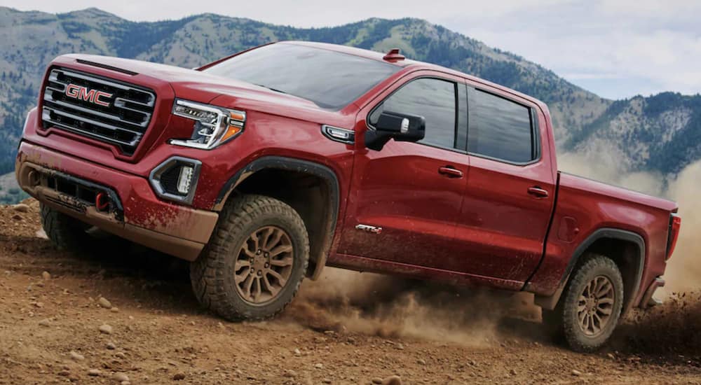 A used red 2021 GMC Sierra AT4 is off-roading.
