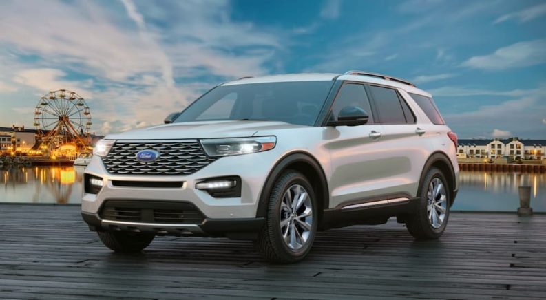 A white 2021 Ford Explorer is shown from the front parked on a dock after winning a 2021 Ford Explorer vs 2021 Chevy Traverse comparison.