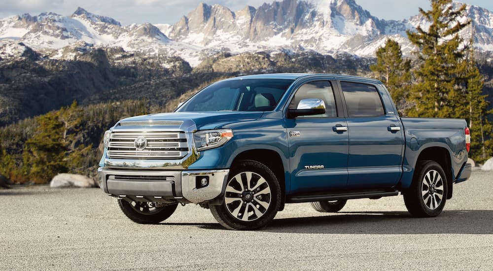 A blue 2021 Toyota Tundra is parked in front of a mountain.