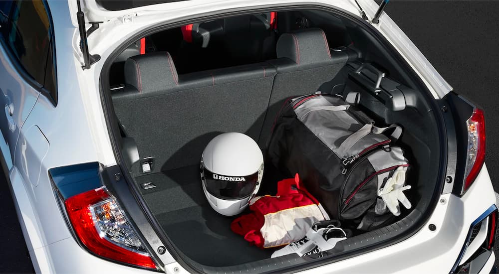 A helmet and race gear is shown in the trunk of a white 2021 Honda Civic Type R.