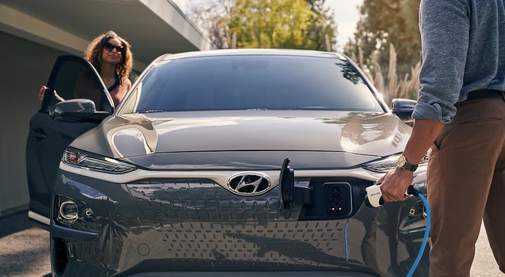A grey 2021 Hyundai Kona Electric shown while being charged.