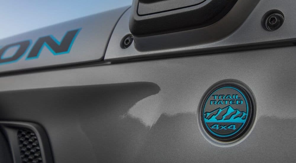 A close up shows the 4x4 trail rated badge on a grey 2021 Jeep Wrangler 4Xe Rubicon.