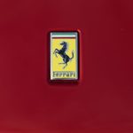 A close up shows the Ferrari logo on the Ferrari Purosangue.