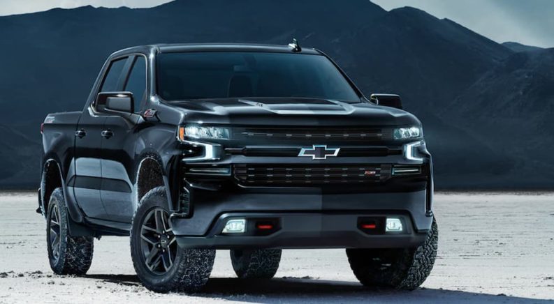 A black 2021 Chevy Silverado is shown parked ona salt flat after winning a 2021 Chevy Silverado vs 2021 Ford F-150 comparison.