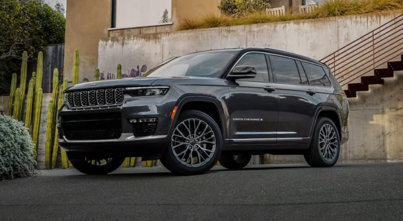 A black 2021 Jeep Grand Cherokee L is shown parked in front of a building after winning a 2021 Jeep Grand Cherokee L vs 2021 Chevy Traverse comparison.
