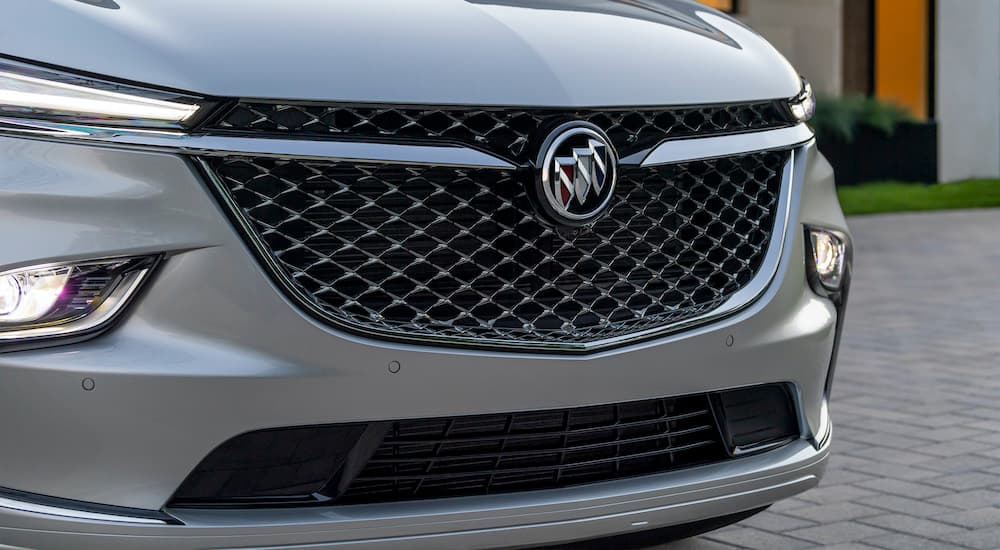 A silver 2022 Buick Enclave shows the grille in close up.