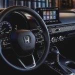 The steering wheel of a 2022 Honda Civic Touring shows the steering wheel and infotainment screen.