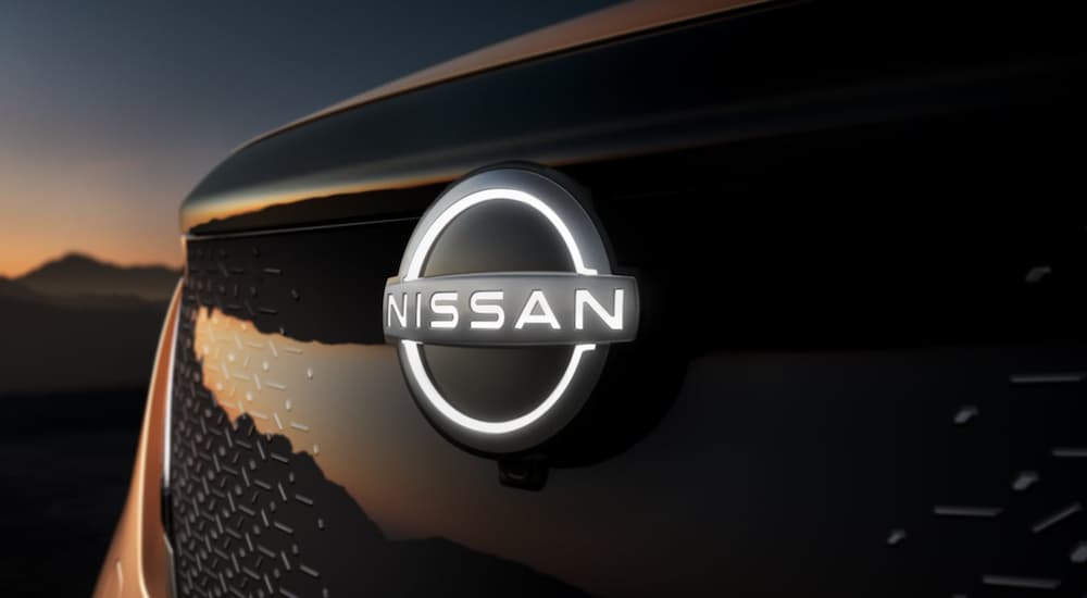 The emblem of a 2022 Nissan Ariya is shown in close up.
