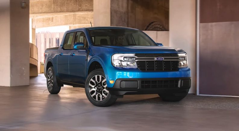 A blue 2022 Ford Maverick Lariat is shown in a concrete space.