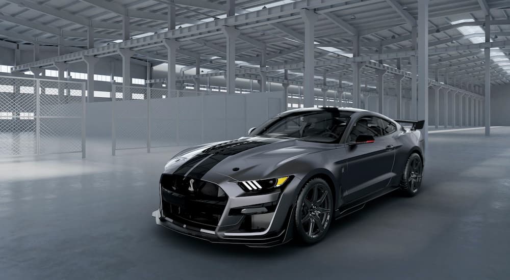 One of the most powerful Ford performance vehicles, a grey 2020 Ford Mustang GT500 Venom, is shown parked in a empty warehouse.