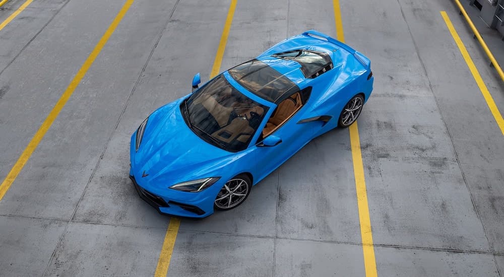 A blue 2022 Chevy Corvette is shown from a high angle in a lot after leaving a Chevrolet dealer.