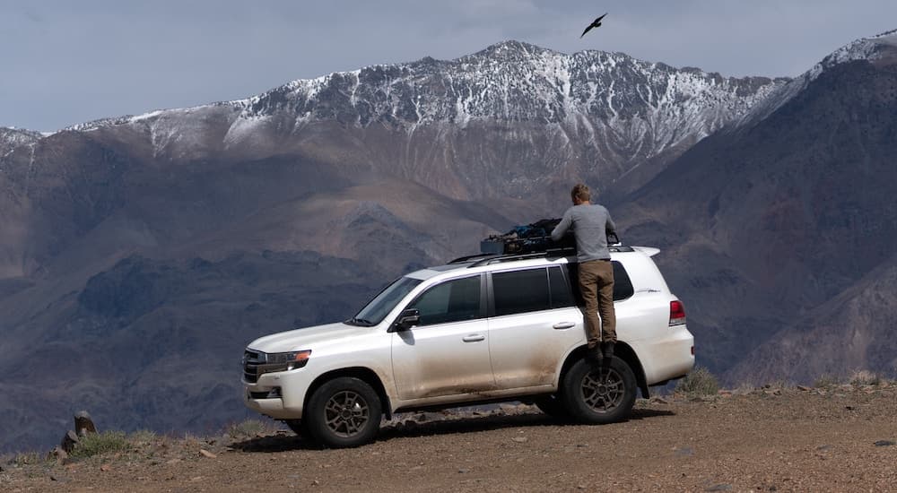 A white 2021 Toyota Land Cruiser Heritage Edition is shown in the mountains.