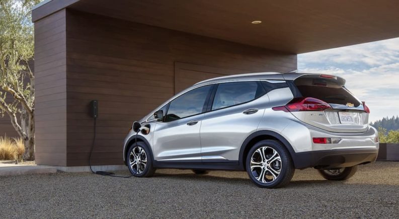 A silver 2021 Chevy Bolt EV at a home charging station
