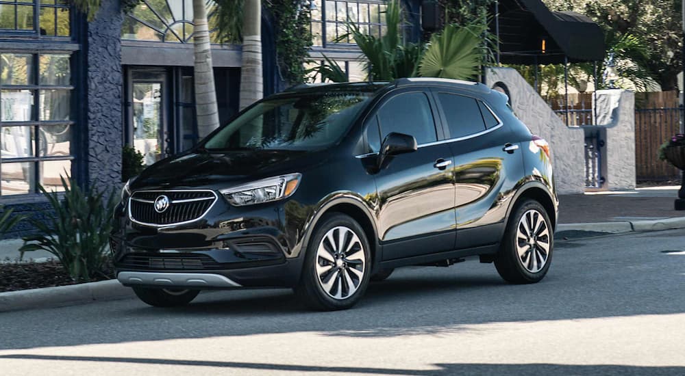 A black 2022 Buick Encore is shown from the side parked on a city street.