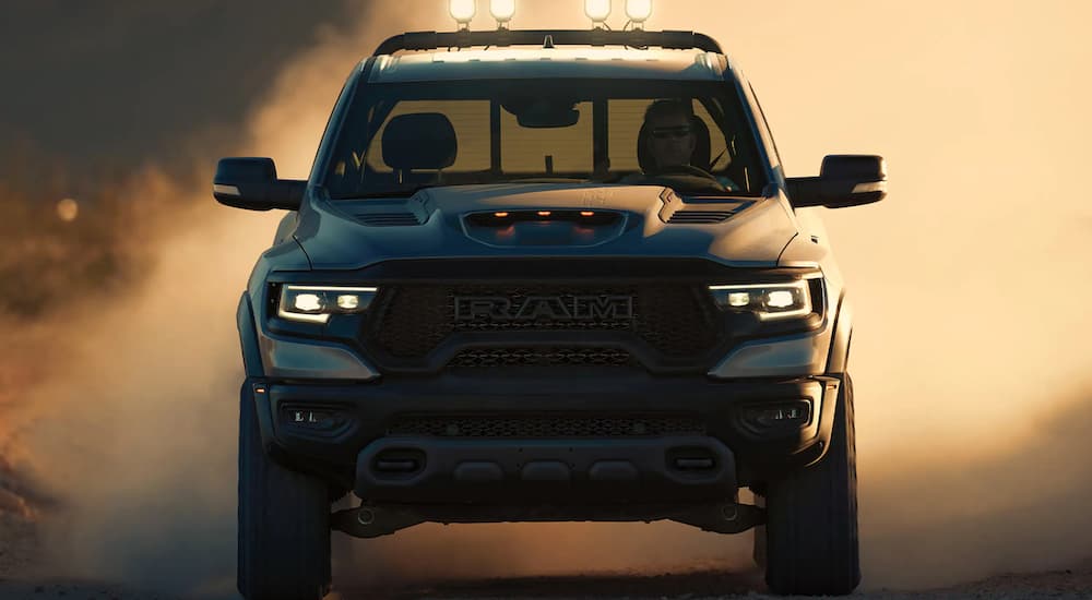 A 2022 Ram 1500 TRX is shown from the front off-roading through a desert.