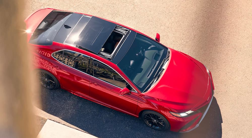 A top view of a red 2022 Toyota Camry XSE V6 is shown parked outside of a building.
