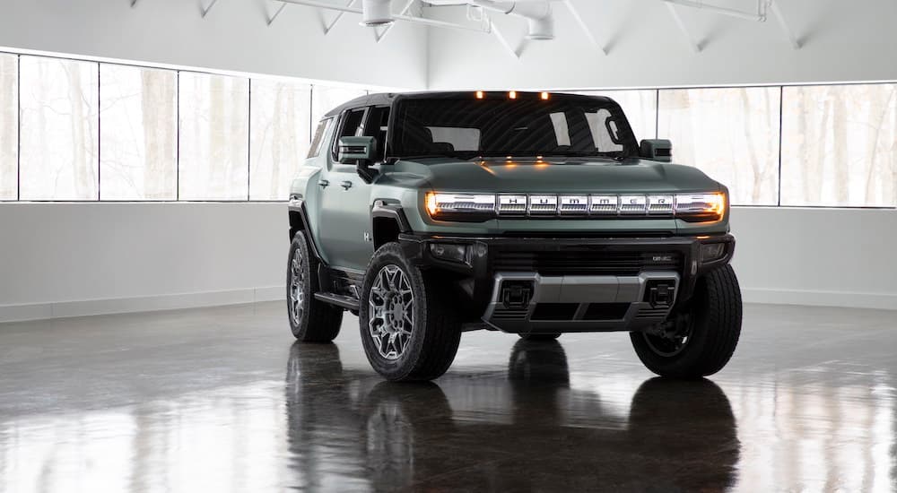 A green 2024 GMC Hummer EV SUV is shown in a showroom after visiting a Honda dealership in Atlanta.