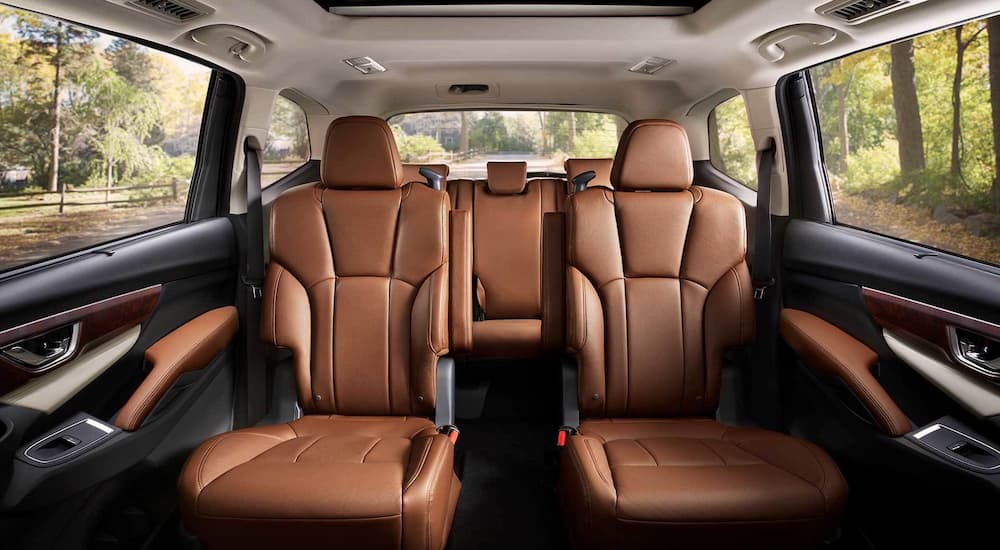 An interior view of the 2022 Subaru Ascent Touring shows the two rear seating rows with black and brown accents at Subaru Ascent Dealer.