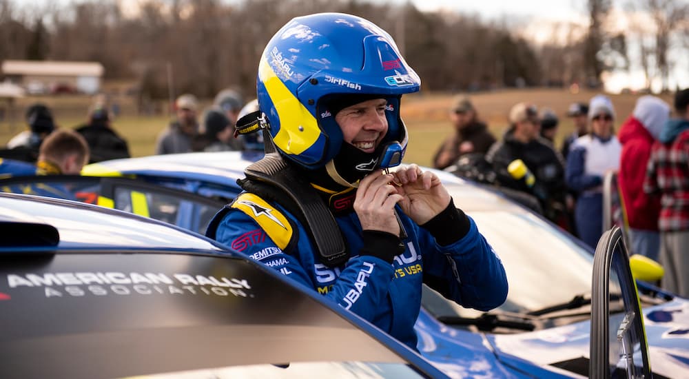 David Higgins is shown removing a race helmet after visiting a Subaru dealer.