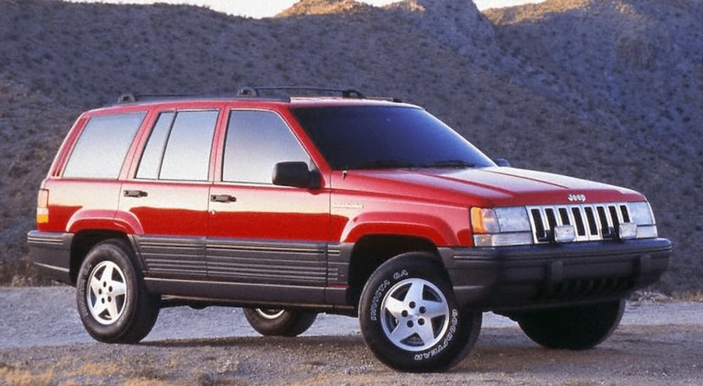 A red 1993 Jeep Grand Cherokee is shown parked in a desert.