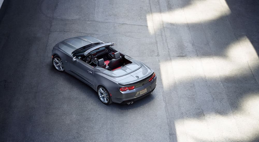A silver 2021 Chevy Camaro Convertible is shown from a high angle parked on concrete.