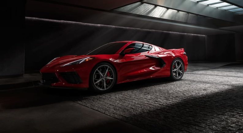 A red 2022 Chevy Corvette Stingray is shown parked in a dark tunnel.