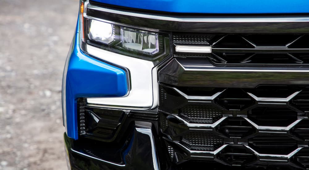 A close up shows the grille and headlight on a blue 2022 Chevy Silverado 1500 ZR2.