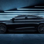 A black 2022 Honda Civic Si is shown from the side in front of neon lights.