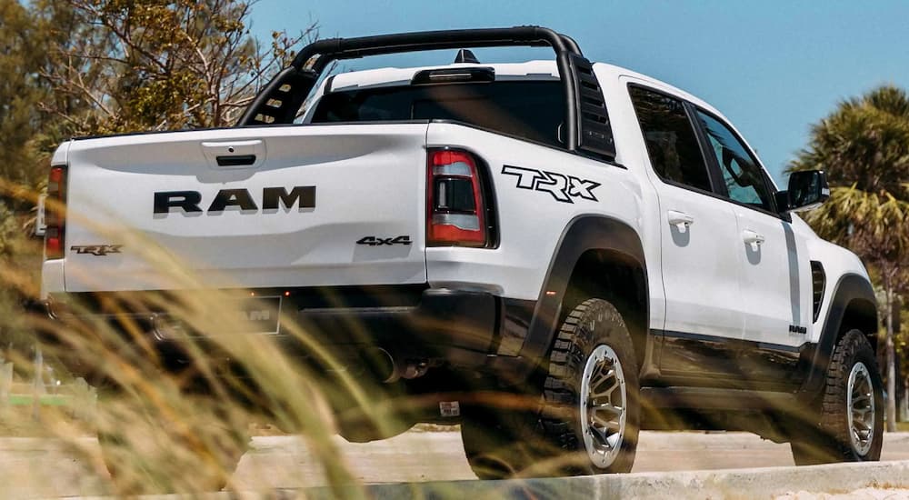 A white 2022 Ram 1500 TRX is shown from a rear angle.