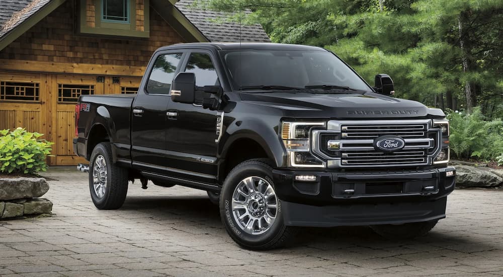 A black 2022 Ford Super F-250 Duty Limited is shown parked in a driveway after leaving a Ford Super Duty dealership.