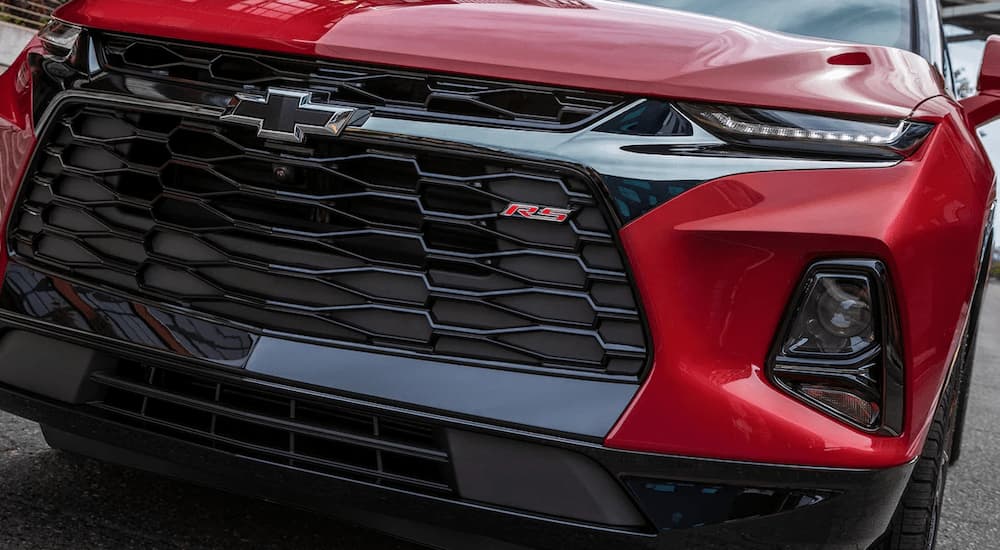 A close up of a red 2021 Chevy Blazer RS shows the grille and headlights.