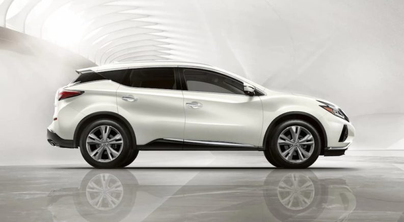 A white 2021 Nissan Murano is shown from the side parked in an empty showroom.