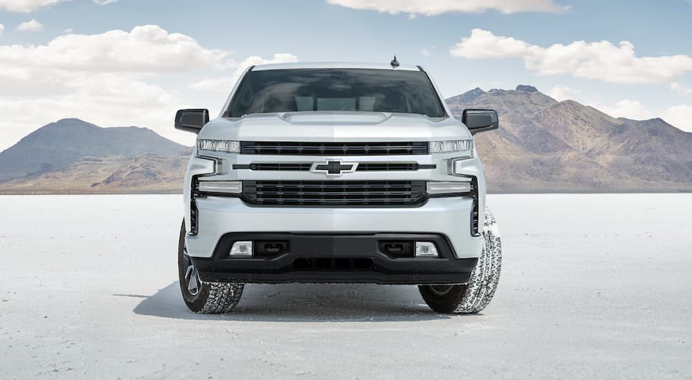 A white 2022 Chevy Silverado 1500 is shown from the front parked on a salt flat.