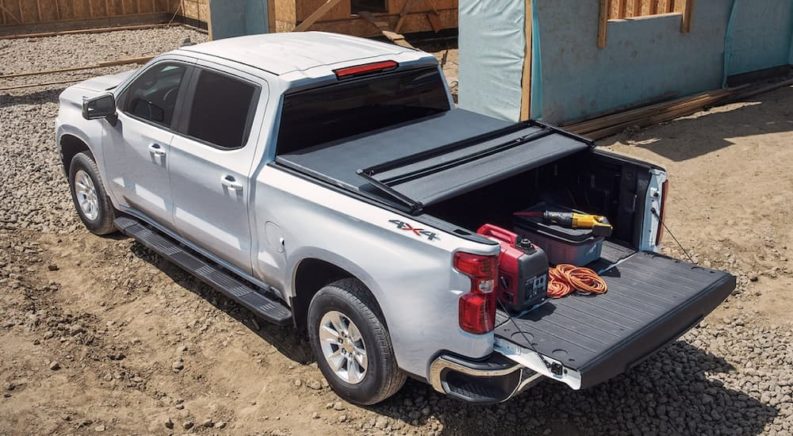 A white 2022 Chevy Silverado 1500 is shown parked at a construction site after winning a 2022 Chevy Silverado 1500 vs 2022 Ram 1500 comparison.