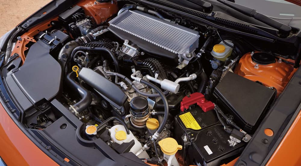A Boxer engine is shown in an orange 2022 Subaru WRX.