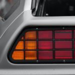 A close up shows the driver side taillight on a silver 1982 DMC Delorean after leaving a Chevy dealer.