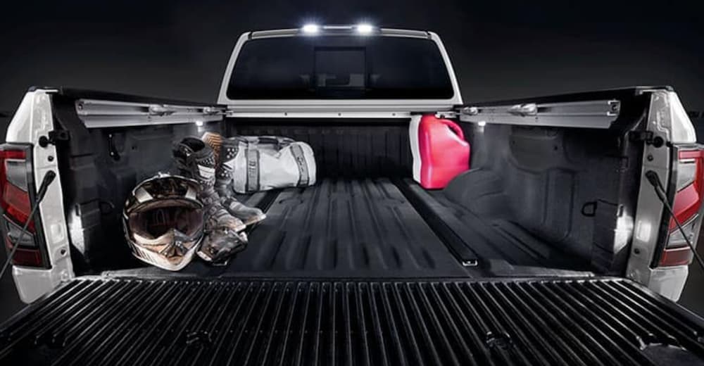 The bed of a white 2020 Nissan Titan is shown in close up.
