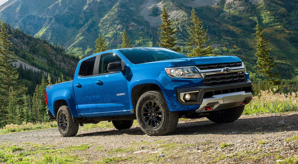 A blue 2022 Chevy Colorado Trail Boss is shown from the front at an angle while off-road.
