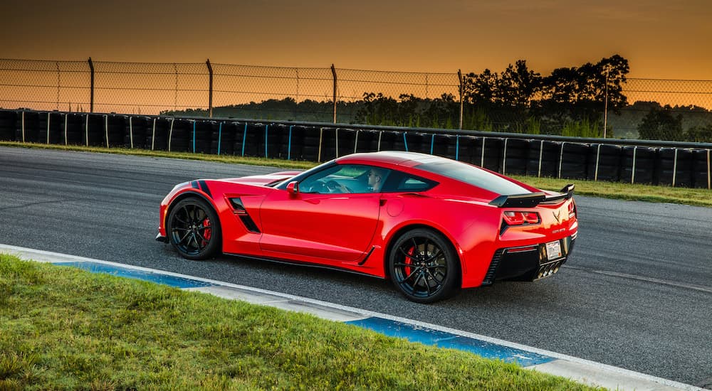 A red 2015 Chevy Corvette Grand Sport with the Z07 package is shown driving on a race track.