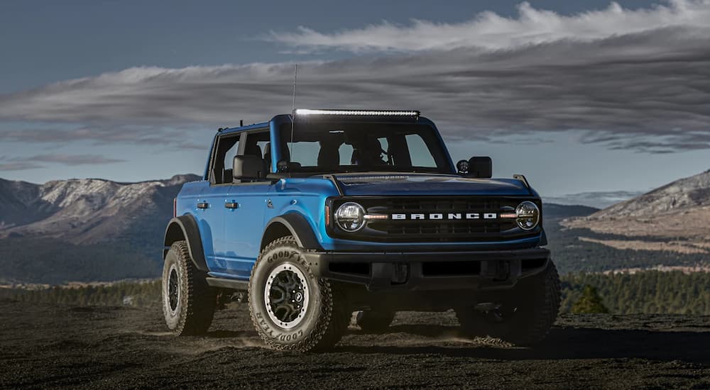 A blue 2021 Ford Bronco Black Diamond with the Sasquatch package is shown parked in a remote area.
