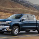 A blue 2022 Chevy Silverado 1500 Limited is shown driving on an open highway.