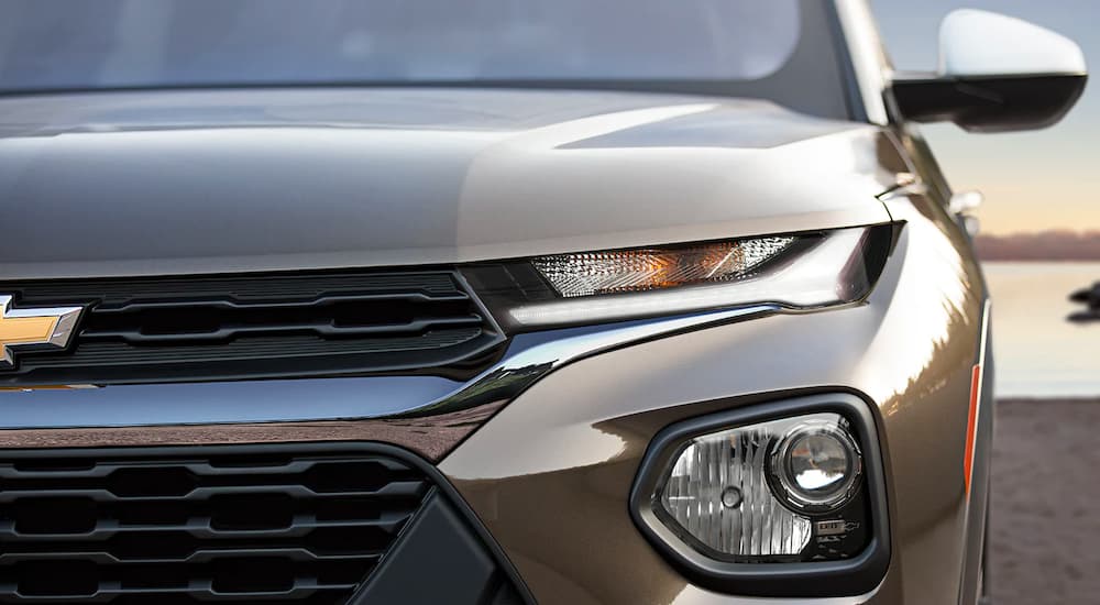A close up shows the driver side headlight on a bronze 2022 Chevy Trailblazer ACTIV.