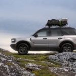 A silver 2022 Ford Bronco Sport Badlands is shown from the side on top of a rocky hill.