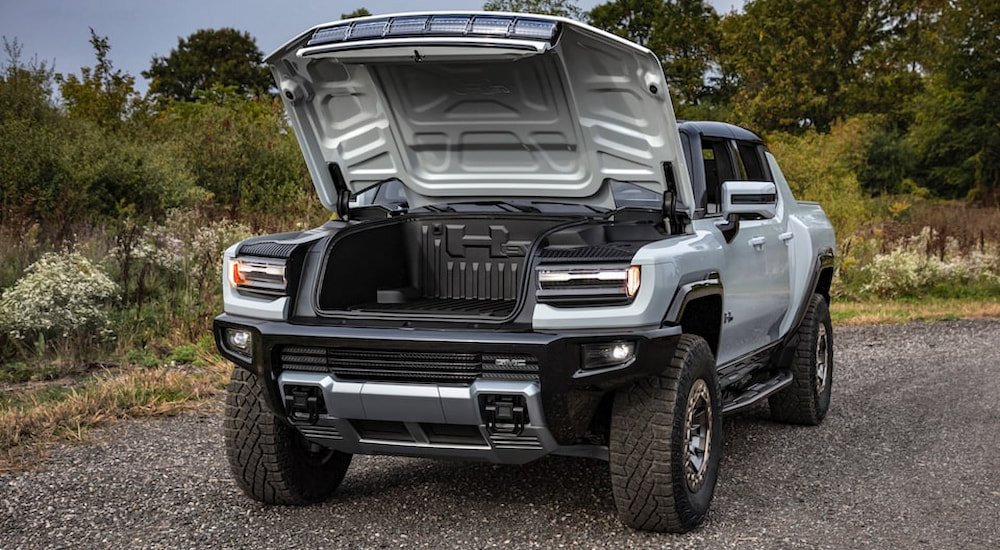 A silver 2022 GMC Hummer EV Pickup is shown with the frunk open.